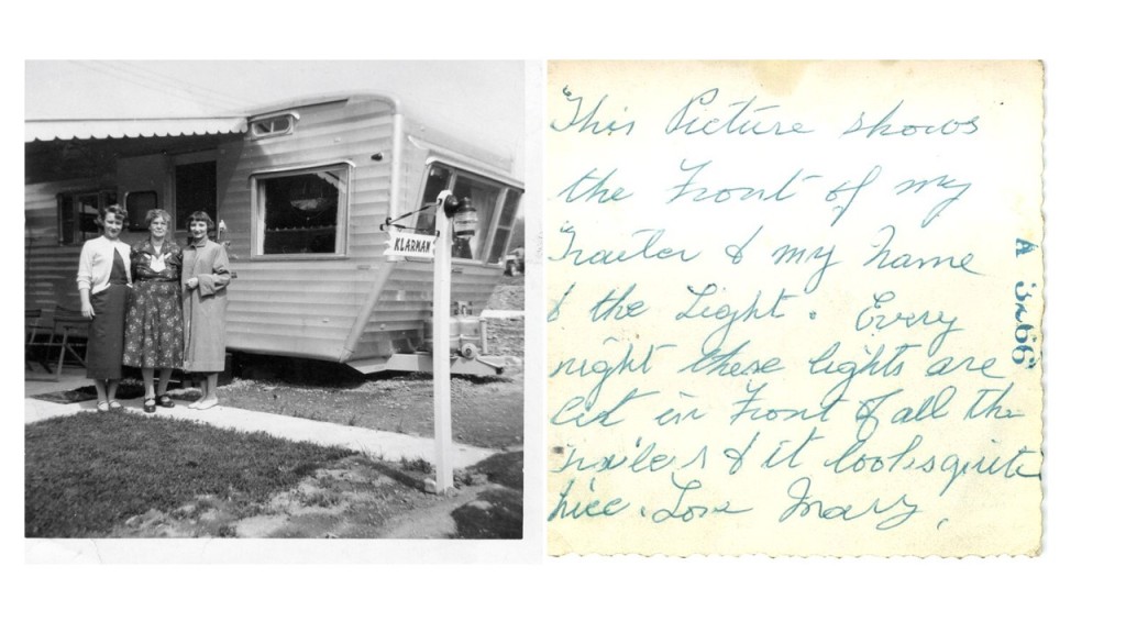 Photo shows an older woman flanked by two younger women. Writing says: "This Picture shows the Front of my Trailer & my Name & the Light. Every night these lights are lit in Front of all the Trailers & it looks quite nice. Love Mary."